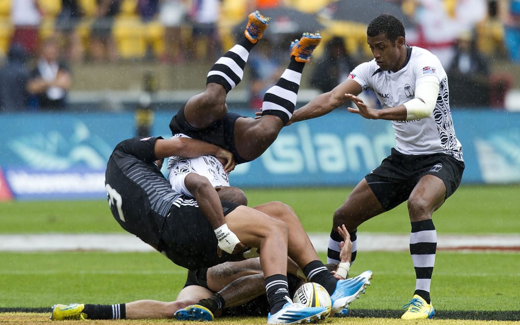 New Zealand's Akira Ioane, left, tackles Jona Tuitoga of Fiji, centre, with Samissoni Viriviri in support.