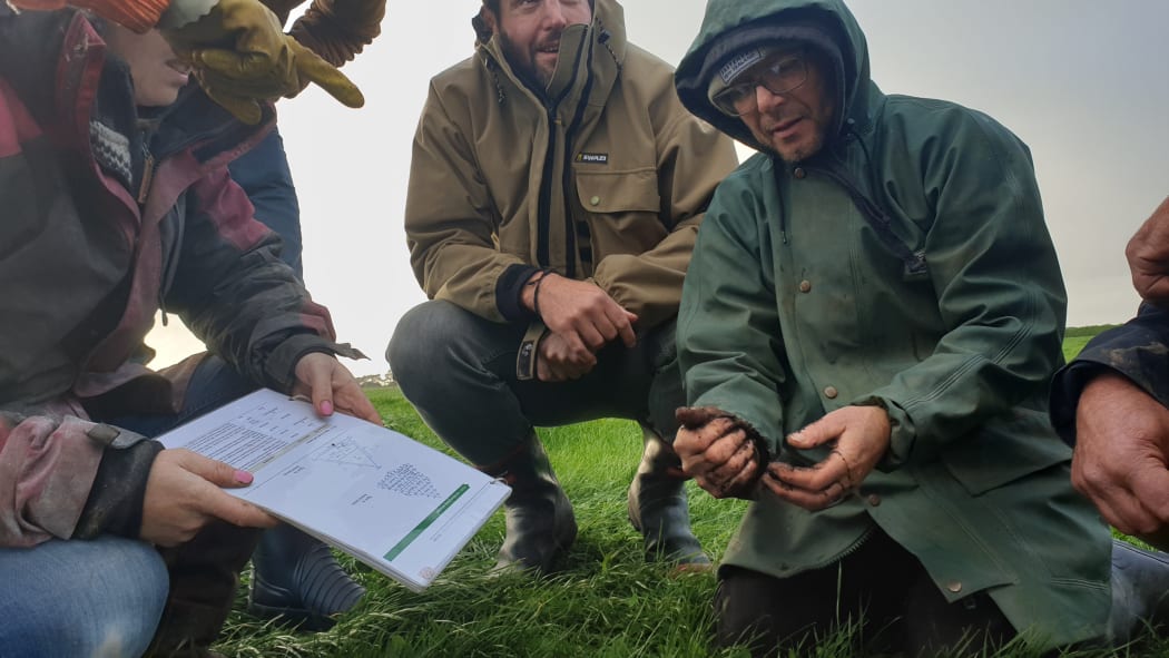 Workshop participants examine soil at the Short's farm