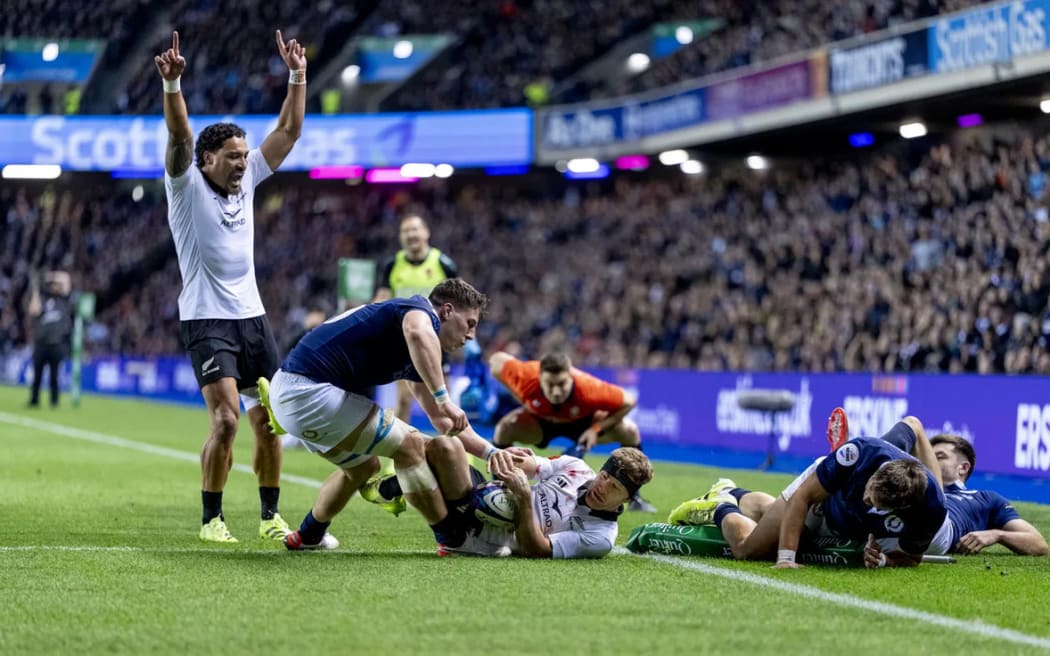 Damian McKenzie scores the winning try against Scotland.
