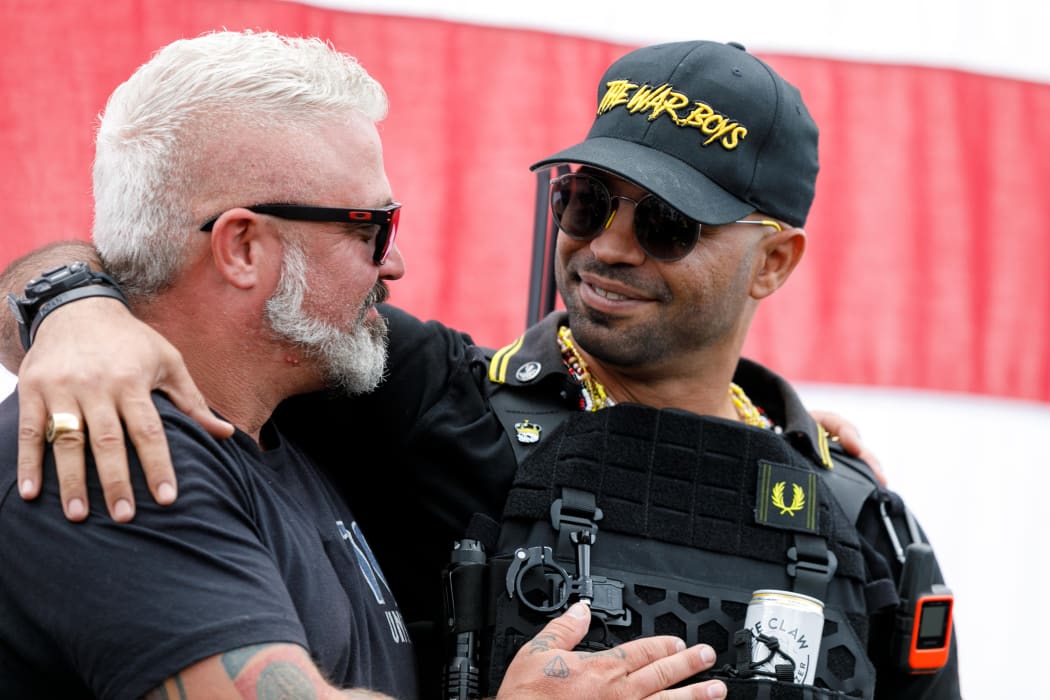 Leaders of the Proud Boys, a right-wing pro-Trump group, Enrique Tarrio (right) and Joe Biggs (left) embrace each other as the Proud boys members gather with their allies in a rally called "End Domestic Terrorism"  against Antifa in Portland, Oregon on 26 September, 2020.