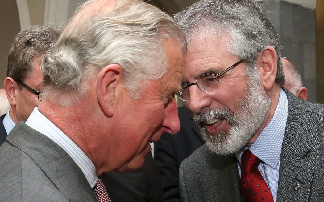 Britain's Prince Charles, left, speaks with Sinn Fein leader Gerry Adams.