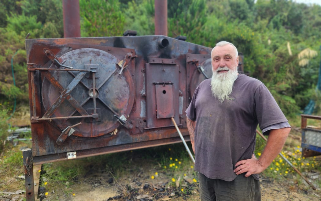 Matt Welton stands in front of his kiln