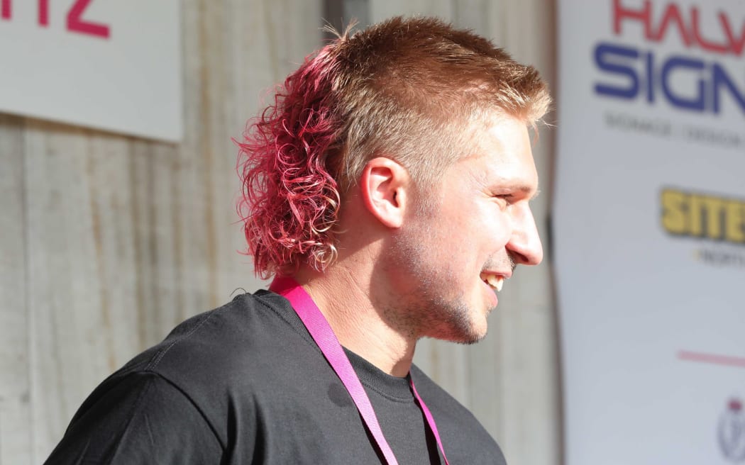 All Black Jack Goodhue got to keep his mullet but made over with pink dye and a perm.