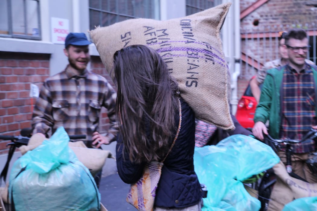 The Wellington Chocolate Factory's Rochelle Harrison carries a sack of Bougainville cocoa beans into the factory. The beans were sailed on the vaka Uto Ni Yalo using traditional navigation techniques.