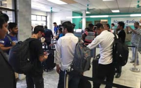 A group of refugees at the airport in Nauru.