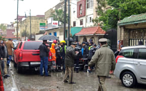 Emergency services gather at the site of illegal underground textile workshop that flooded after heavy rain fall in Morocco's city of Tangiers.