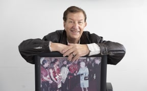 Trevor Maxwell with his photo of meeting the Queen in 2012.