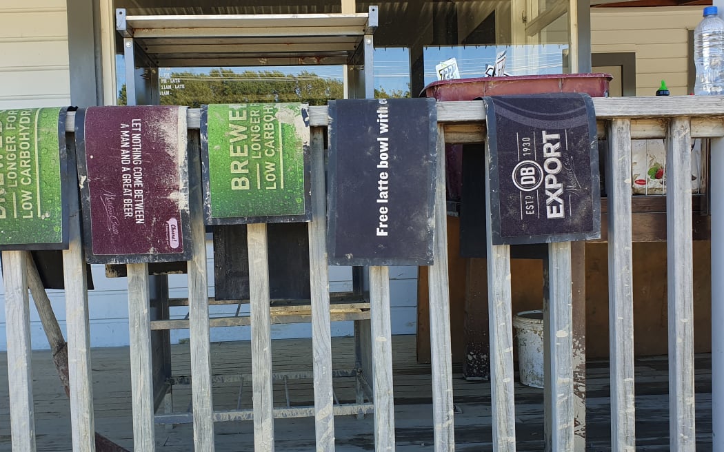 Beer mats hung outside the Tīnui pub Wairarapa, during the clean-up post Cyclone Gabrielle