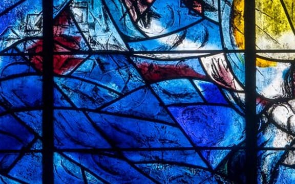 A close up of abstract shapes from stained glass Chagall windows, All Saints, Tudeley, Kent.