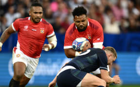 Tonga's back row Sione Vailanu (up) is tackled by Scotland's fly-half Finn Russell   during the France 2023 Rugby World Cup Pool B match between Scotland and Tonga at Stade de Nice in Nice, southern France on September 24, 2023. (Photo by CHRISTOPHE SIMON / AFP)