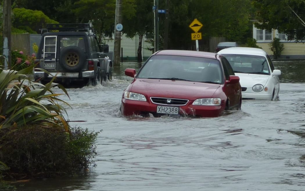 Cars struggle through floods on Matlock Street in Woolston.