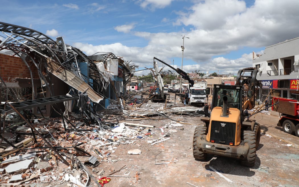 Heavy machinery cleans up the debris caused by the tornado that hit the city of Rio Bonito do Iguacu, Parana State, Brazil on November 8, 2025.