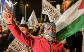 Hundreds gathered spontaneously outside the Israeli Consulate General in Ankara, Turkey, on October 17 to protest the Israeli airstrike on Al-Ahli Baptist Hospital in Gaza. Photo by Mert Can Bukulmez / Middle East Images / Middle East Images via AFP