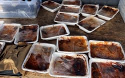 The pictures show the lunches the Whangarei school received with their packaging already coming off and burnt.