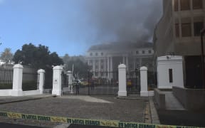 Firefighters are dispatched to extinguish a fire at the Parliament building in Cape Town, South Africa.