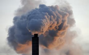 In a file picture taken on 2 January 2009, heavy smoke billows from the chimney of the Kraft paper factory in Pietarsaari, Finland.