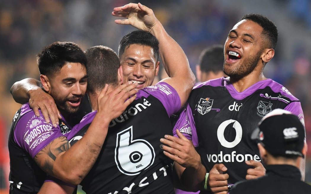 The Warriors celebrate Blake Green's try against the Knights.