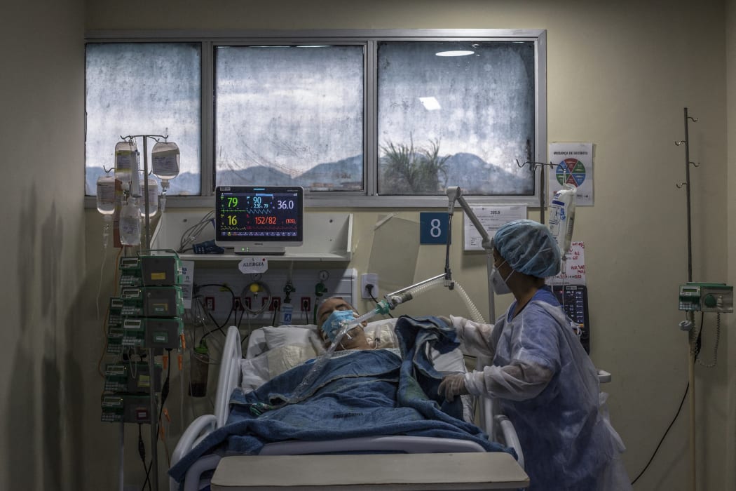 A health worker cares for a Covid-19 patient at an Intensive Care Unit (ICU) of the Ronaldo Gazolla Public Municipal Hospital in Rio de Janeiro, Brazil.