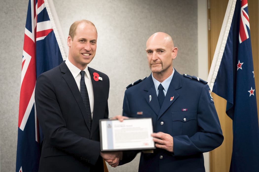 Senior Constable Scott Carmody receiving an award from Prince William.