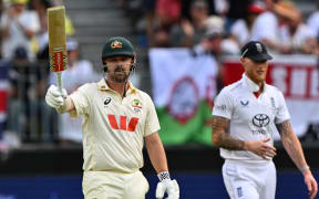 Australia’s Travis Head celebrates reaching his half century (50-runs) on day 2 of the first Ashes cricket Test match between Australia and England at Perth Stadium in Perth on 22 November, 2025.
