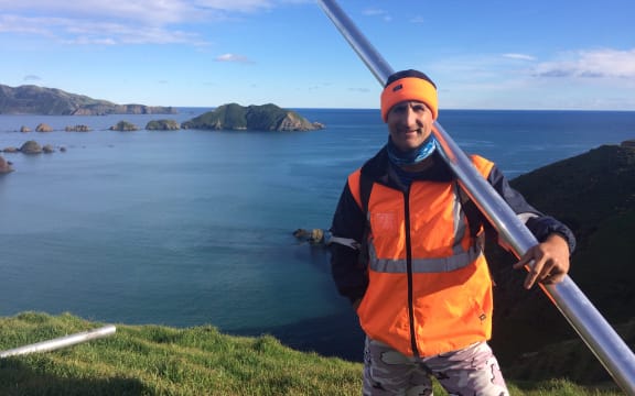 Dr Dan Hikuroa at Rangitoto ki te Tonga holds an aluminum core tube as part of fieldwork research.