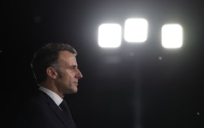 France's President Emmanuel Macron looks on whle addressing French troops during a ceremony at the 5th Cuirassier Regiment's base in Zayed Military City, near Abu Dhabi, on December 21, 2025. Macron arrived in the United Arab Emirates on December 21 to celebrate Christmas with French troops and to discuss bilateral ties with the Gulf state, as France hopes for more cooperation in its fight against drug trafficking. (Photo by Ludovic MARIN / AFP)