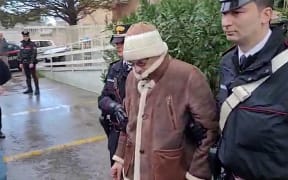 This handout video grab taken and released by the Italian Carabinieri Press Office on January 16, 2023 shows the arrest by Carabinieri of the Italy's top wanted mafia boss, Matteo Messina Denaro in Palermo, in his native Sicily after 30 years on the run. - Italian anti-mafia police caught Sicilian godfather Matteo Messina Denaro on January 16, 2023, ending a 30-year manhunt for Italy's most wanted fugitive. The mobster was nabbed "inside a health facility in Palermo, where he had gone for therapeutic treatment", special operations commander Pasquale Angelosanto said in a statement released by the police. (Photo by Handout / ITALIAN CARABINIERI PRESS OFFICE / AFP) / RESTRICTED TO EDITORIAL USE - MANDATORY CREDIT "AFP PHOTO / HANDOUT / ITALIAN CARABINIERI PRESS OFFICE " - NO MARKETING NO ADVERTISING CAMPAIGNS - DISTRIBUTED AS A SERVICE TO CLIENTS