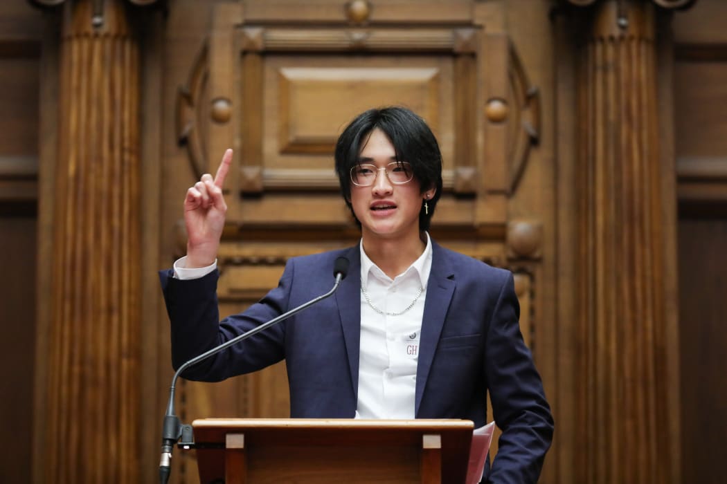 Tony Huang (Onslow College) at the podium leading into a joke