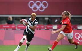 Fiji's Aloesi Nakoci (L) runs past Britain's Alex Matthews to score a try in the women's bronze medal rugby sevens match.