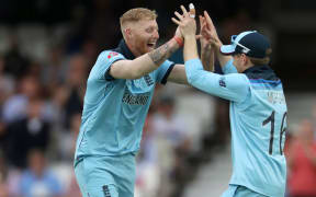 England's Ben Stokes celebrates with captain Eoin Morgan.