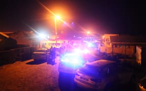 Police outside a township pub in South Africa's southern city of East London on 26 June, 2022, after at least 22 young people died inside.