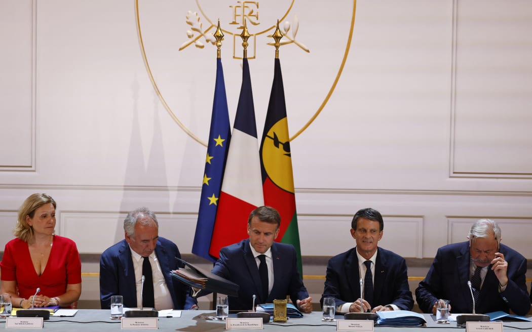 President of the French National Assembly Yael Braun-Pivet (L), France's Prime Minister Francois Bayrou, France's President Emmanuel Macron, France's Minister of Overseas Manuel Valls and President of the French Senate Gerard Larcher  attend a session of a summit on New Caledonia at the Elysee Palace in Paris on July 2, 2025. After months of “patient work” and three return trips to New Caledonia, France's Minister of Overseas is hoping to reach a compromise between independentists and loyalists at the “summit” that begins on July 2. (Photo by Ludovic MARIN / POOL / AFP)