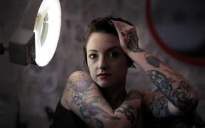 A portrait of Char, showing her tattoos
