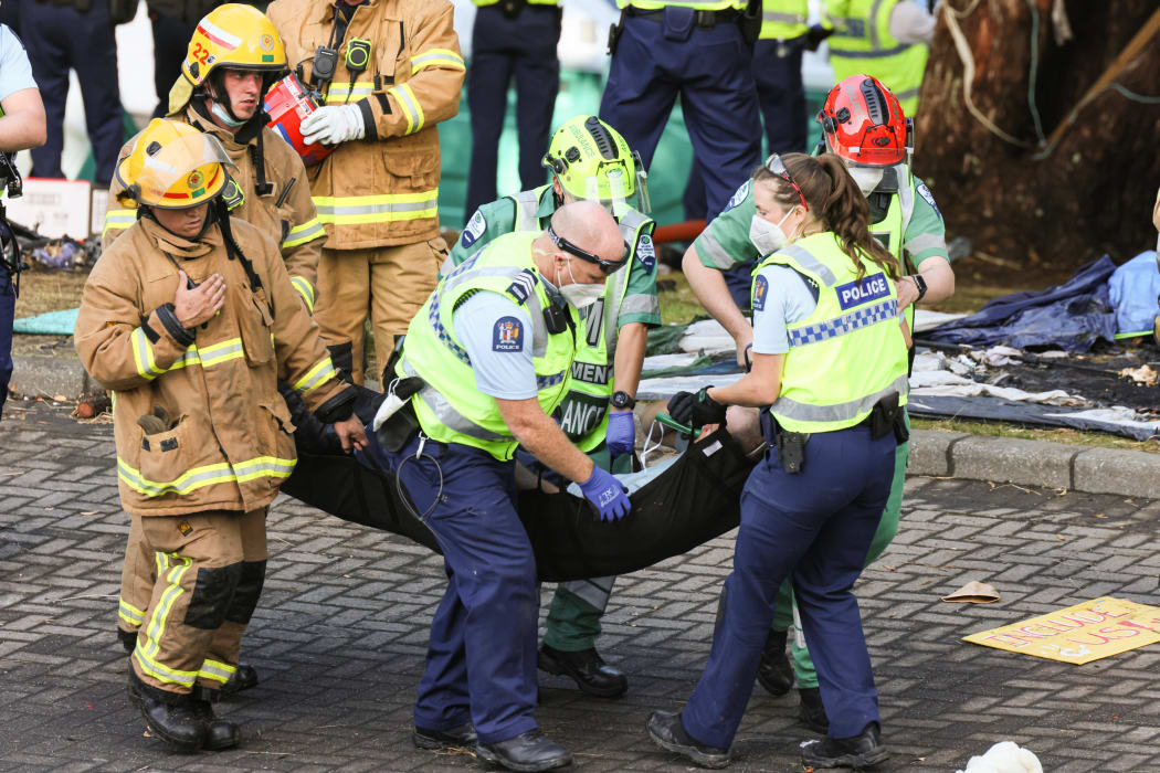 An injured police officer is carried away