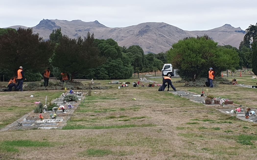 Council workers preparing Memorial Park Cemetery in Christchurch.