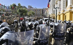 Military troops are deployed outside the Quemado Palace at the Plaza Murillo in La Paz on 26 June.