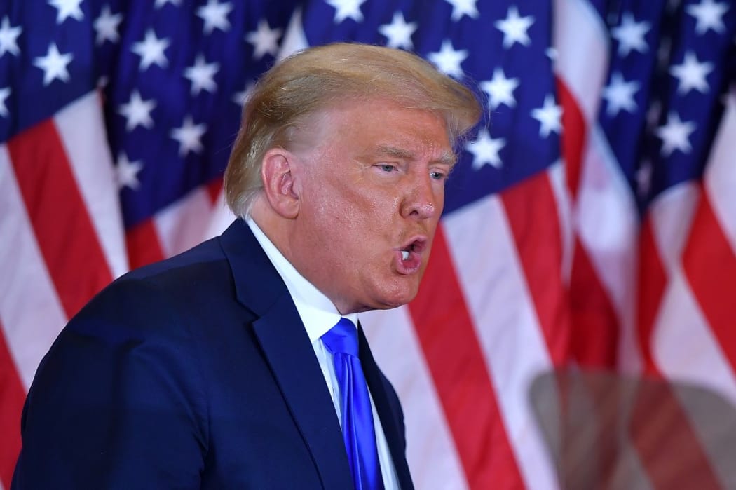 US President Donald Trump gestures after speaking during election night in the East Room of the White House in Washington, DC, early on November 4, 2020. (Photo by MANDEL NGAN / AFP)
