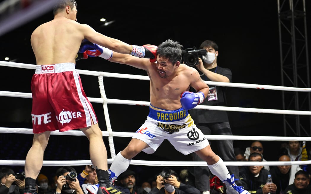 Manny Pacquiao (R) fights DK Yoo of South Korea during their exhibition boxing match in Goyang, South Korea  on December 11, 2022.