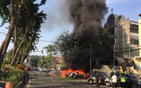 A Surabaya local government photo shows police at the site of a blast outside the Gereja Pantekosta Pusat Surabaya.