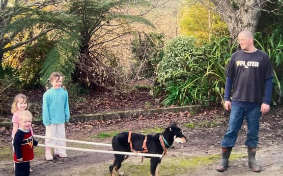 Clark Chrystal with his three children training their dog Hendrix