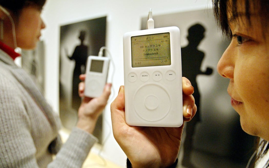 Exhibition-goers use Apple's early iPod models to listen to an explanation of contemporary Japanese artwork at the Mori Art Museum in Tokyo, on 18 February, 2004.