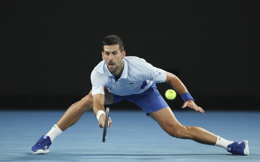 Novak Djokovic hits a return against Adrian Mannarino