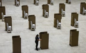 A worker assembles voting booths at a polling station in Cali, Colombia