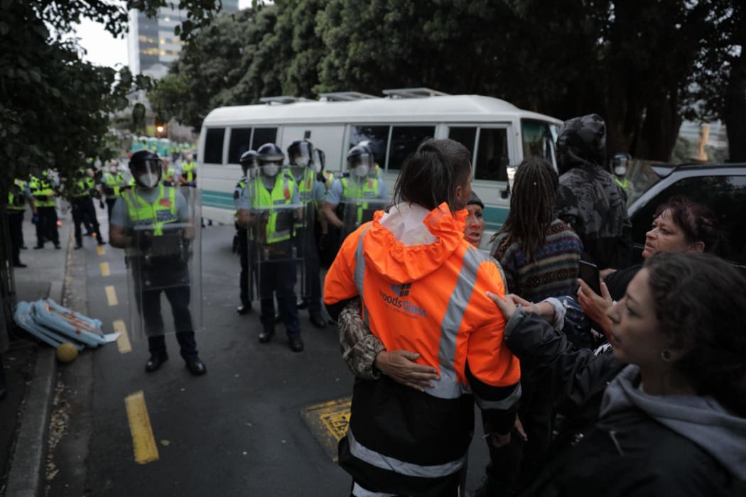 Police undertake an early morning operation to restore order and access to the area around Parliament.