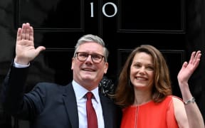 Britain's incoming Prime Minister Keir Starmer and leader of the Labour Party, and his wife Victoria wave as they pose on the steps of 10 Downing Street in London on July 5, 2024, a day after Britain held a general election. Starmer became Britain's new prime minister, as his centre-left opposition Labour party swept to a landslide general election victory, ending 14 years of right-wing Conservative rule. (Photo by JUSTIN TALLIS / AFP)