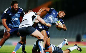 The Blues' Charles Piutau tries to escape tacklers