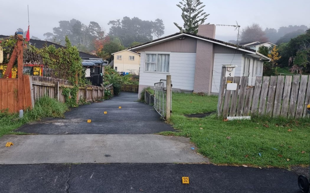 Markers on a driveway in Vina Place, Massey, as police investigated reports of shots fired.