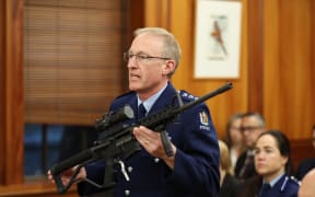 Mike McIlraith is the officer in charge of the Arms Act service delivery group with an AR15 military style rifle.