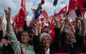 Supporters of the main opposition Republican People's Party (CHP) wave flags during an election rally, ahead of the 28 May presidential runoff vote, in Istanbul, Turkey. 27 May, 2023.