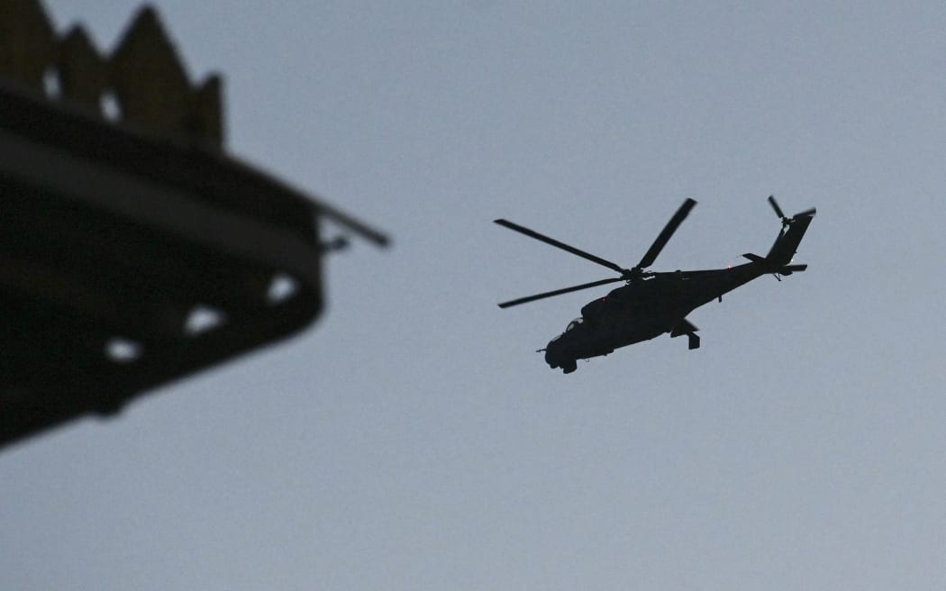 A Myanmar Air Force Mi-35 flies over the sky in Lashio, Shan state on August 24, 2019.